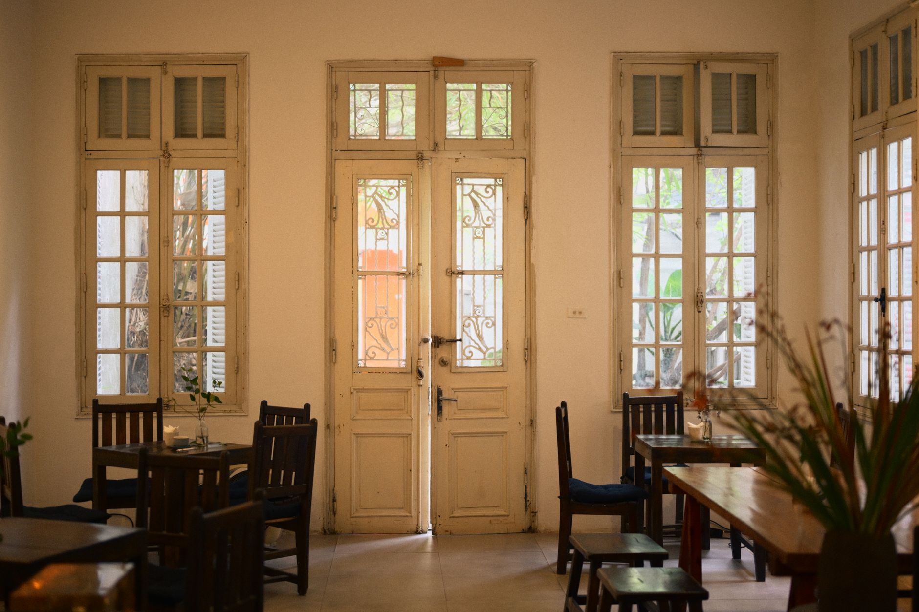 Charming vintage-style cafe interior with wooden furniture and soft, natural lighting.